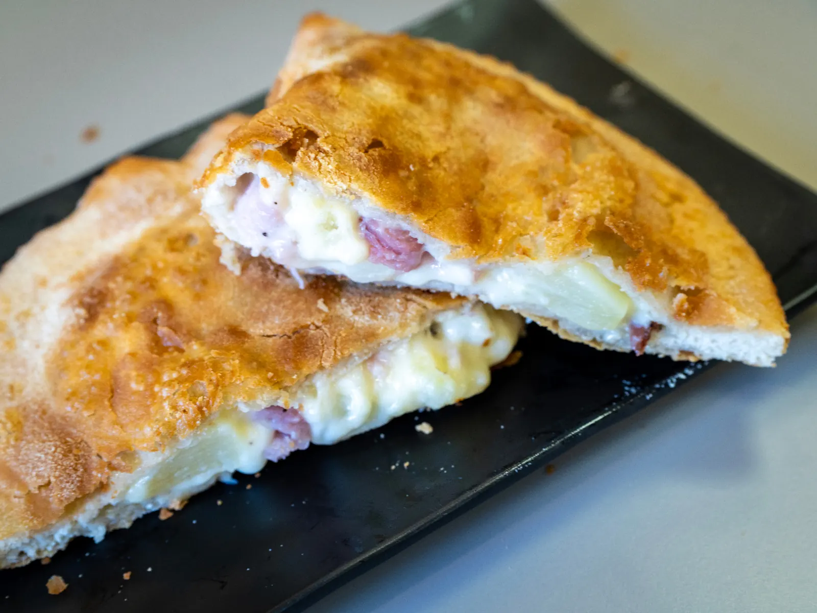 Handmade Sicilian panzerotto — golden fried dough pocket with melted filling